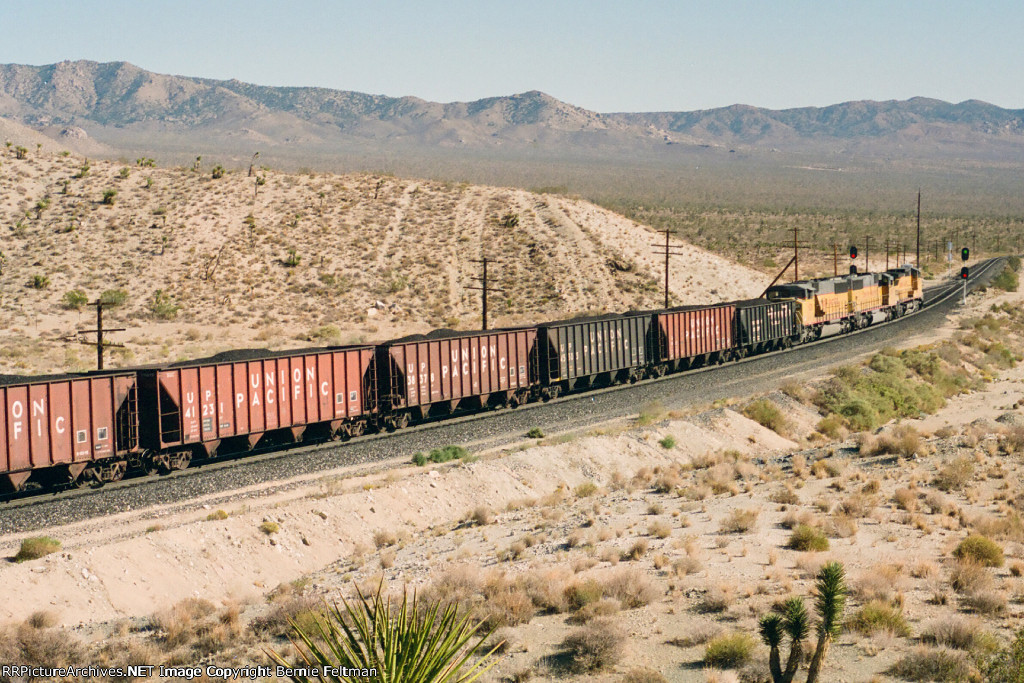 Union Pacific C40-8W #9379 (with SD60M's 6255 & 6311) begins its slow descent down Cima Hill in full dynamic braking 